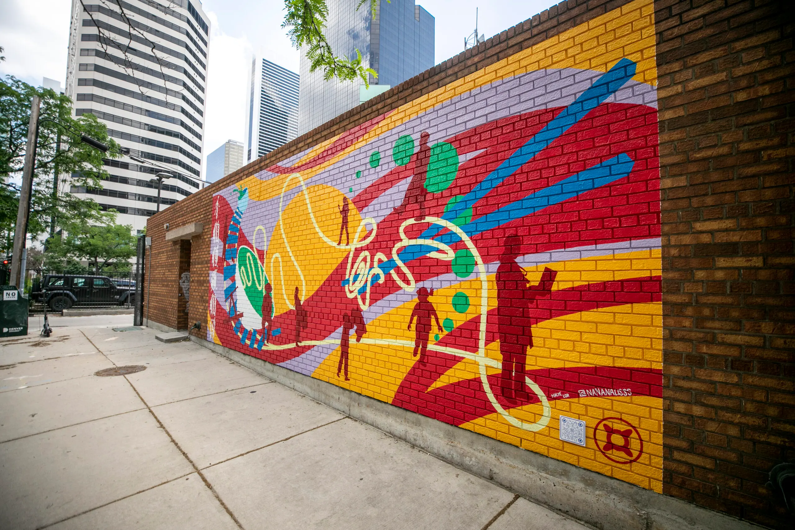 A photograph of Denver's Chinatown mural by Nalye Lor on a brick wall.